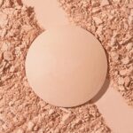Suggest a better title and return a single title only without any other comments: LAURA GELLER NEW YORK Baked Double Take Powder Foundation - Porcelain - Buildable Medium to Full Coverage - Matte Finish - Image 9
